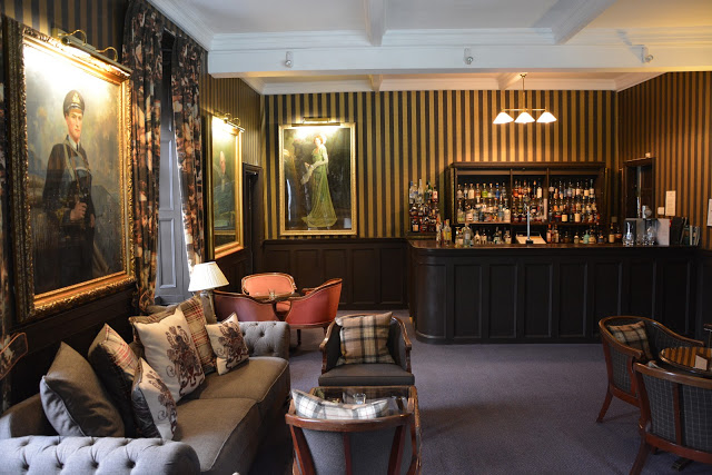 Relax with a whisky by the fire in the bar at Bunchrew House